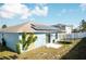 View of the home's backyard featuring solar panels, a trampoline and fenced perimeter at 318 Elderberry Ct, Kissimmee, FL 34759