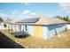 The home's backyard showing solar panels, the roof line and a trampoline at 318 Elderberry Ct, Kissimmee, FL 34759