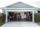 This garage features a clean epoxy floor with plenty of storage space at 318 Elderberry Ct, Kissimmee, FL 34759