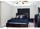 Primary bedroom features a king-sized bed, tray ceiling, and dark furniture at 318 Elderberry Ct, Kissimmee, FL 34759