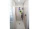 This bathroom features a walk in shower with a mounted caddy for storage at 318 Elderberry Ct, Kissimmee, FL 34759