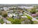 Aerial view of home showcasing mature landscaping and nearby amenities at 403 Poinciana Cir, Kissimmee, FL 34744