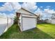 Detached garage with white siding and roof in the fenced backyard at 403 Poinciana Cir, Kissimmee, FL 34744