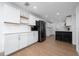 Bright kitchen with white cabinetry, stainless steel appliances, and a breakfast bar at 403 Poinciana Cir, Kissimmee, FL 34744