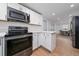 Bright kitchen featuring stainless steel appliances, ample counter space, and an open layout at 403 Poinciana Cir, Kissimmee, FL 34744