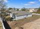 Aerial view of the backyard with a gray house, sliding glass door, and an AC unit at 408 Danube Dr, Poinciana, FL 34759