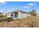 Backyard of a gray house with a sliding glass door and an AC unit at 408 Danube Dr, Poinciana, FL 34759