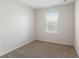 Empty bedroom with neutral carpet, window, and freshly painted walls at 408 Danube Dr, Poinciana, FL 34759