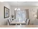 Elegant dining room featuring a modern chandelier, stylish seating, and ample natural light at 408 Danube Dr, Poinciana, FL 34759