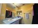 Bathroom featuring a large mirror, vanity, towel rack, and bathtub with shower curtain at 414 Otter Creek Dr, Kissimmee, FL 34743