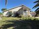 View of the side of the home showing the bay window and the lawn at 414 Otter Creek Dr, Kissimmee, FL 34743