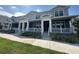 Three blue townhomes with covered porches, white railings, and landscaped front yards at 452 Diamond Dove Cv, Winter Springs, FL 32708