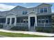 Well-maintained townhomes showcase inviting front porches, classic columns, and lush landscaping at 452 Diamond Dove Cv, Winter Springs, FL 32708