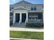 Charming townhome featuring a covered front porch and white railing, perfect for enjoying the outdoors at 452 Diamond Dove Cv, Winter Springs, FL 32708
