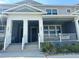 Charming townhome featuring a covered front porch and white railing, perfect for enjoying the outdoors at 452 Diamond Dove Cv, Winter Springs, FL 32708