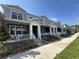 Street view of blue townhomes with covered porches, white railings, and landscaped front yards at 452 Diamond Dove Cv, Winter Springs, FL 32708