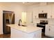 Bright kitchen with white cabinetry, modern stainless steel appliances, and center island at 452 Diamond Dove Cv, Winter Springs, FL 32708