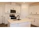 Modern kitchen featuring white cabinets, stainless steel appliances, and a quartz island at 452 Diamond Dove Cv, Winter Springs, FL 32708