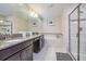 Elegant bathroom featuring granite countertops, a soaking tub and a glass enclosed shower at 4768 Kings Castle Cir, Kissimmee, FL 34746