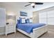 Comfortable bedroom with a white bed frame, blue patterned bedding and cool coastal decor at 4768 Kings Castle Cir, Kissimmee, FL 34746