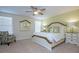 Bright bedroom features a ceiling fan, large bed, and decorative mirror at 4768 Kings Castle Cir, Kissimmee, FL 34746