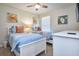 Comfortable bedroom with two beds featuring cool coastal decor and nautical themed artwork at 4768 Kings Castle Cir, Kissimmee, FL 34746