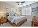 Cozy bedroom with wooden furniture, soft blue accents, and natural light from the window at 4768 Kings Castle Cir, Kissimmee, FL 34746