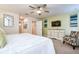 Bright bedroom featuring a ceiling fan, a dresser with a TV, and a patterned accent chair at 4768 Kings Castle Cir, Kissimmee, FL 34746