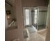 Bathroom features a glass shower, white tile, and a door to the exterior at 4807 Wingrove Blvd, Orlando, FL 32819