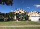 Inviting single-story home with lush landscaping, well-manicured lawn, and a charming front entrance at 4807 Wingrove Blvd, Orlando, FL 32819