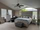 Serene main bedroom featuring a vaulted ceiling, large windows, and a comfortable bed with stylish furnishings at 4807 Wingrove Blvd, Orlando, FL 32819