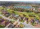 Bird's-eye view of a residential area near a lake and golf course, highlighting neighborhood layout at 538 Via Vitale Ct, Kissimmee, FL 34759