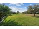 A lush green lawn extends to the golf course from the home's mature landscaping, providing a serene outdoor setting at 538 Via Vitale Ct, Kissimmee, FL 34759