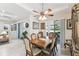 Traditional dining room with wooden table, decorative chairs, and sliding doors to the outdoors at 538 Via Vitale Ct, Kissimmee, FL 34759