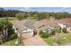 Aerial view of a well-maintained home with mature landscaping, a brick driveway, and an attached two-car garage at 538 Via Vitale Ct, Kissimmee, FL 34759