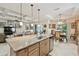 Modern kitchen featuring a center island with granite countertops, stainless steel appliances and tile flooring at 538 Via Vitale Ct, Kissimmee, FL 34759