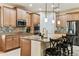 Kitchen featuring granite counters, stainless appliances, tile backsplash, and barstool seating at the island at 538 Via Vitale Ct, Kissimmee, FL 34759