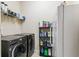 Functional laundry room with appliances and shelving for organized storage solutions at 538 Via Vitale Ct, Kissimmee, FL 34759