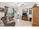 Cozy living room features tile floors, neutral paint, ceiling fan and natural light from sliding glass doors at 538 Via Vitale Ct, Kissimmee, FL 34759