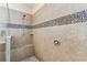 Shower featuring neutral tile, glass doors, built-in bench and rainfall shower head at 538 Via Vitale Ct, Kissimmee, FL 34759