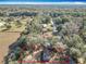 Aerial view of the property, outlining in red the house and surrounding trees within the landscape at 6189 Nw 68Th St, Ocala, FL 34482