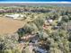 Expansive aerial view of the property, showcasing the house, trees, and surrounding acreage at 6189 Nw 68Th St, Ocala, FL 34482