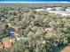 Overhead view of the home situated in a verdant, wooded area with nearby agricultural fields at 6189 Nw 68Th St, Ocala, FL 34482