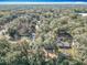 Aerial view of the property, revealing the house surrounded by dense trees and winding roads at 6189 Nw 68Th St, Ocala, FL 34482