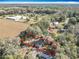 Aerial view of property showing the house nestled among trees, bordered in red and surrounded by greenery at 6189 Nw 68Th St, Ocala, FL 34482