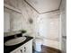 Bathroom featuring marble-look walls, a shower-tub combo, and a white vanity at 6189 Nw 68Th St, Ocala, FL 34482