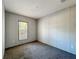 Bedroom featuring neutral carpet, light walls, a window, and electrical outlets at 6189 Nw 68Th St, Ocala, FL 34482