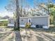 Gray house with white trim surrounded by a grassy area and scattered trees at 6189 Nw 68Th St, Ocala, FL 34482