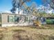 Charming single-story home featuring a gray exterior, black shutters, and a well-maintained front yard at 6189 Nw 68Th St, Ocala, FL 34482