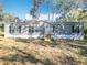 Charming single-story home featuring a gray exterior, black shutters, and a well-maintained front yard at 6189 Nw 68Th St, Ocala, FL 34482